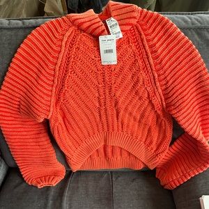 Orange/coral, never worn Free People sweater with tags.